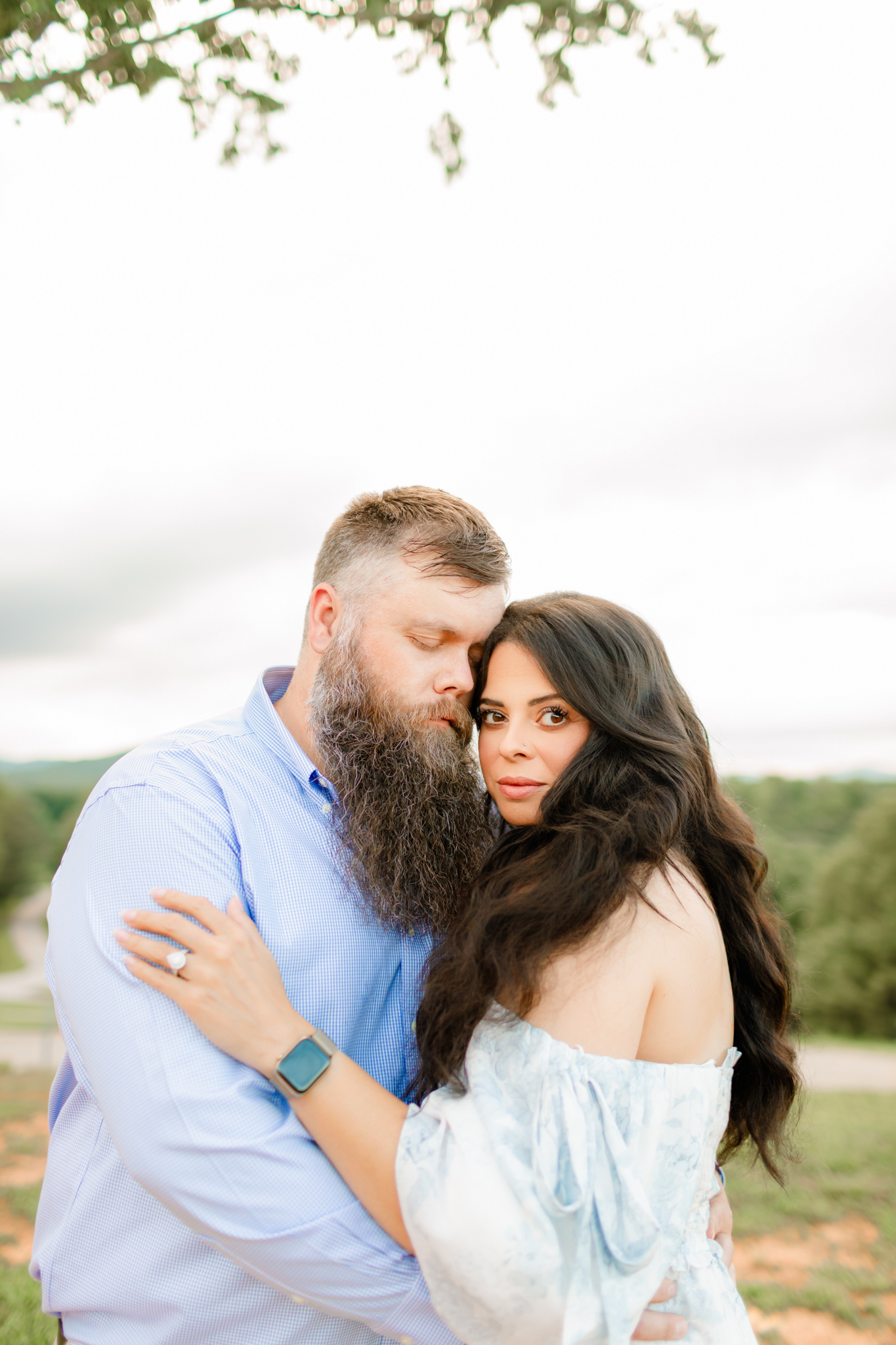 Husband and wife embracing outdoors, symbolizing strength, love, and faith through life’s struggles.