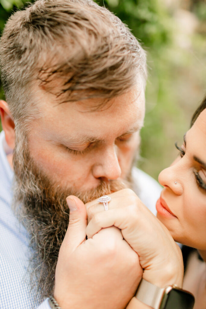 Husband kissing wife’s hand in a quiet moment of love and commitment