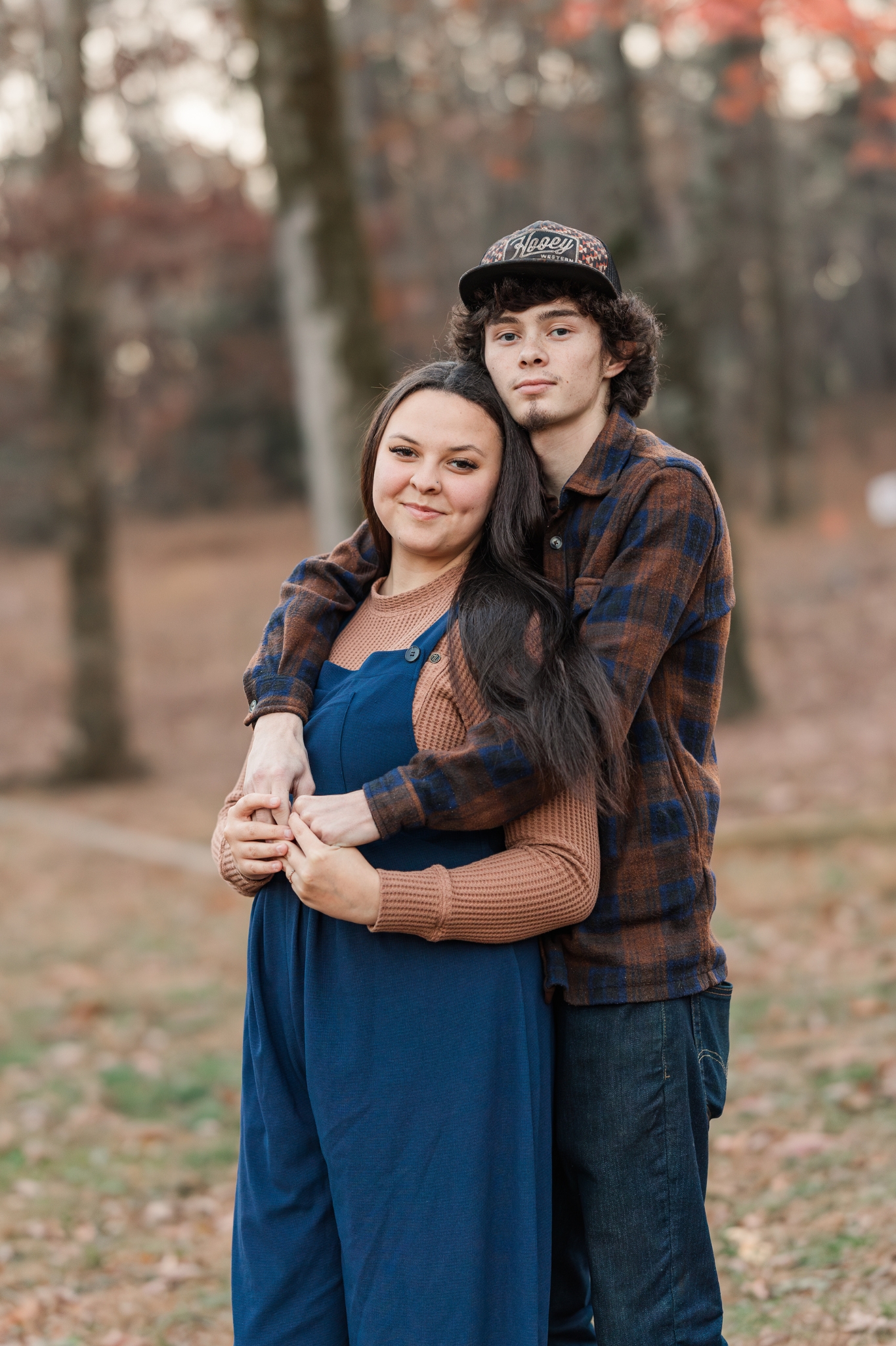 Couple embracing outdoors in warm natural light, representing authentic storytelling and faith-based photography.